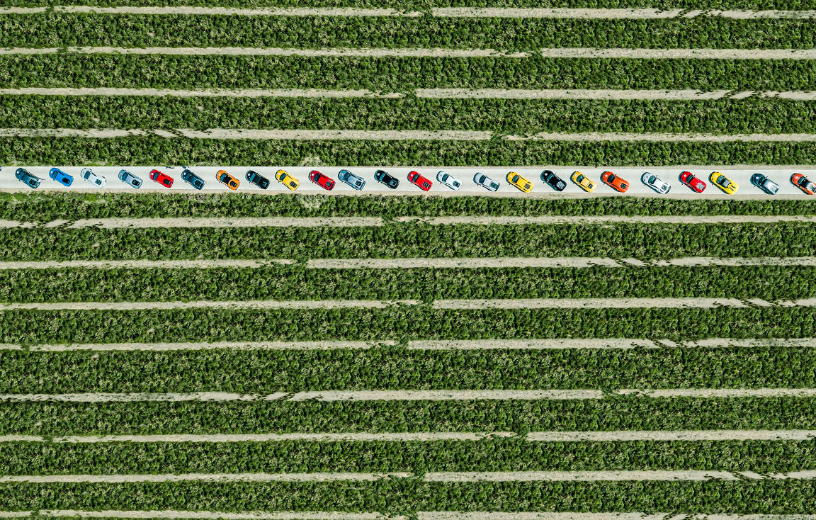 Lamborghinis seen from above and parked next to each other in symmetrical fields.